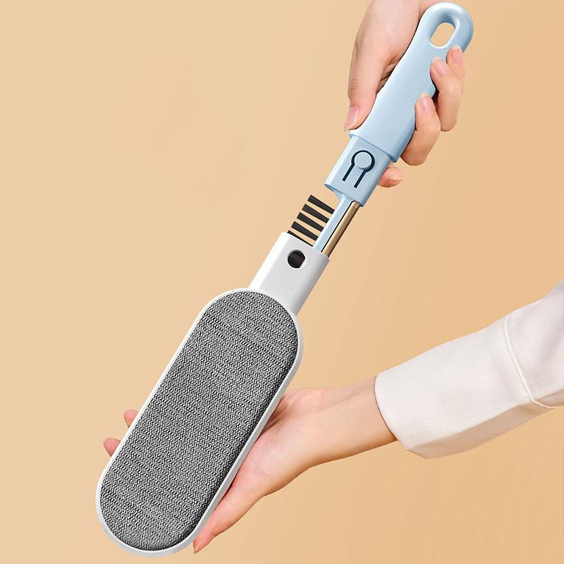 Hand holding reusable lint remover with textured roller, ideal for pet hair and fabric care