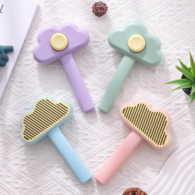 Pastel cloud-shaped pet grooming brushes with gold combs on textured white surface
