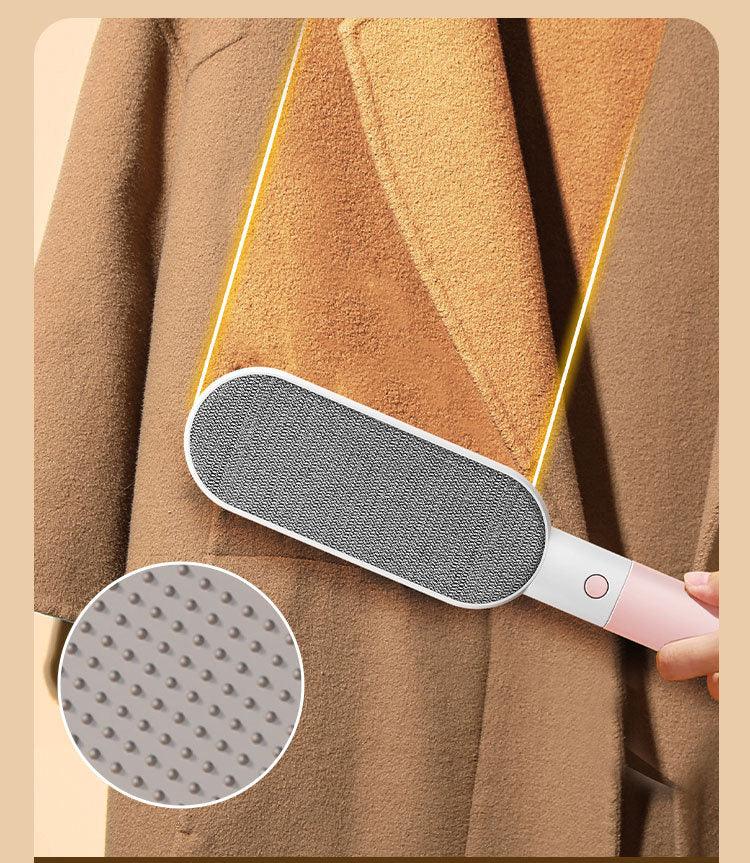 Electric lint remover brushing brown coat, close-up of textured roller for pet hair removal
