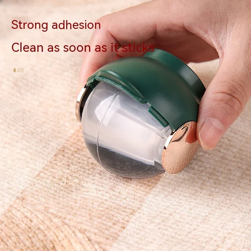 Hand holding reusable pet hair remover ball with strong adhesion for cleaning carpets and furniture